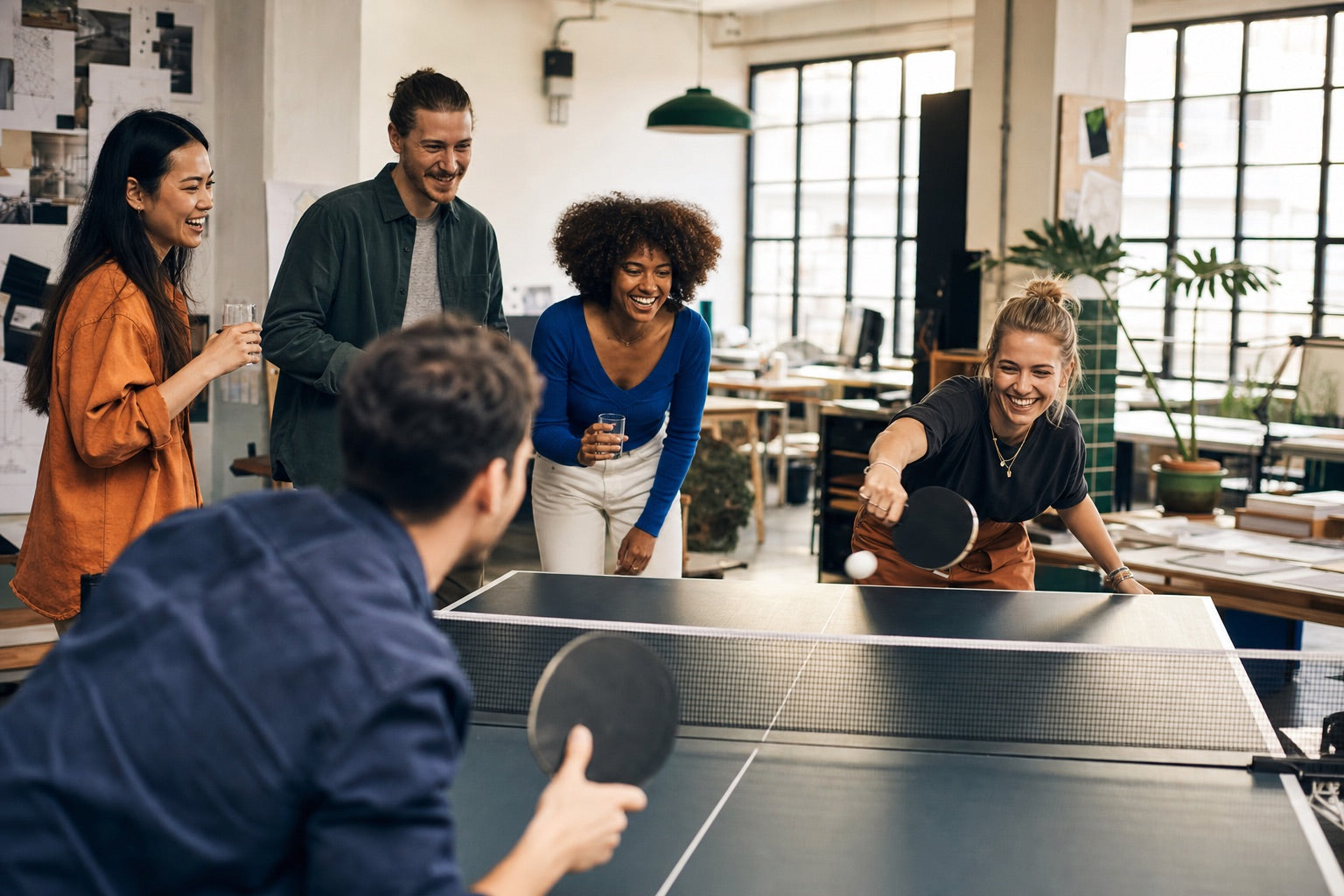 Team einer Kreativagentur trifft sich zu einer Runde Tischtennis
